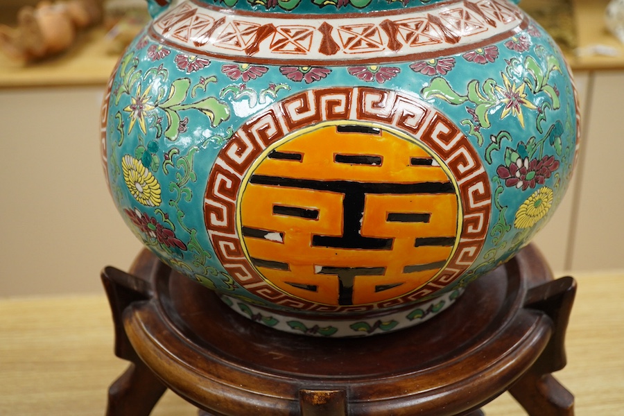 A Chinese double-gourd vase and cover, on associated hardwood stand, total height 65cm. Condition - fair to good